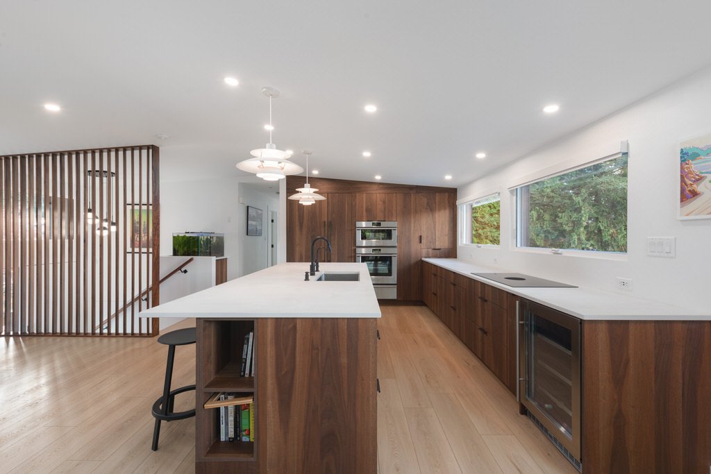 Modern custom kitchen with recessed ceiling lights and pendant lighting above the island